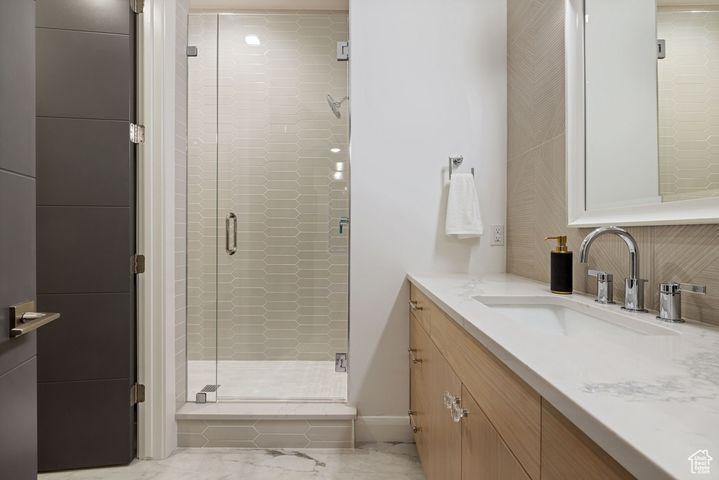 Bathroom with walk in shower, large vanity, and tile floors