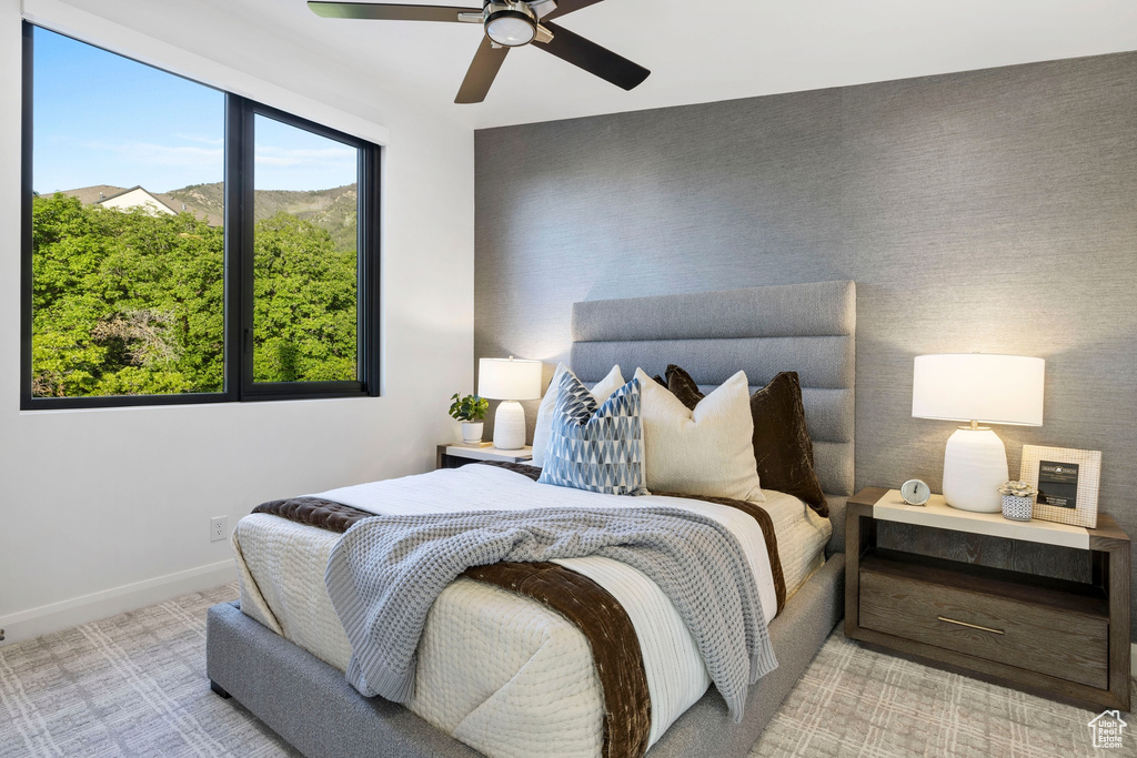 Bedroom featuring light carpet and ceiling fan