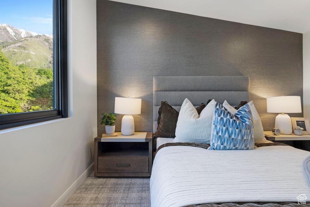 Bedroom featuring carpet flooring and lofted ceiling