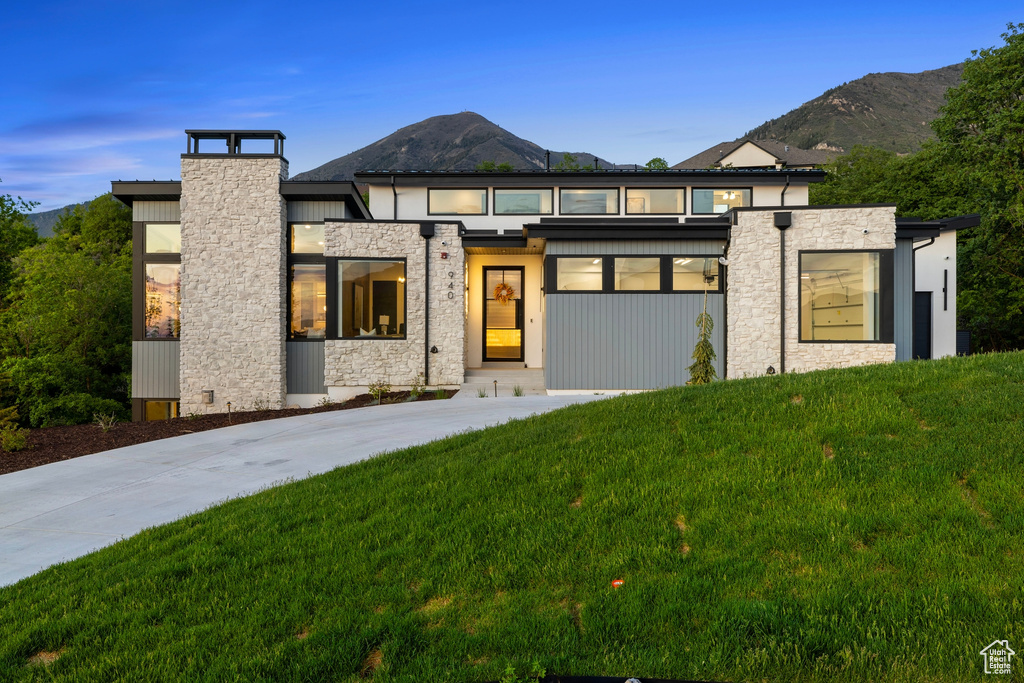 View of front of property with a yard and a mountain view