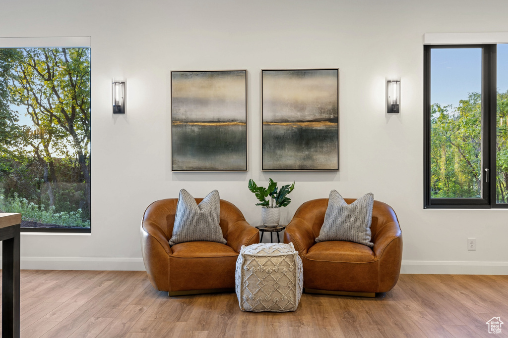 Sitting room with a wealth of natural light and hardwood / wood-style flooring