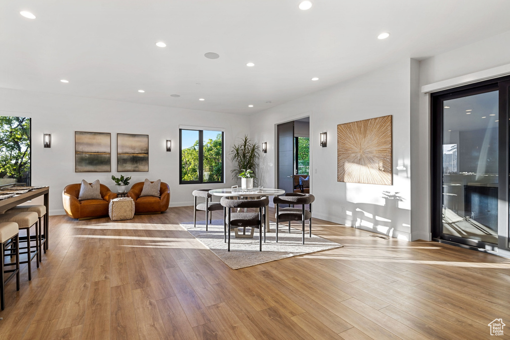 Dining space with hardwood / wood-style flooring