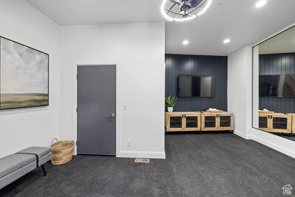 Living room featuring dark colored carpet