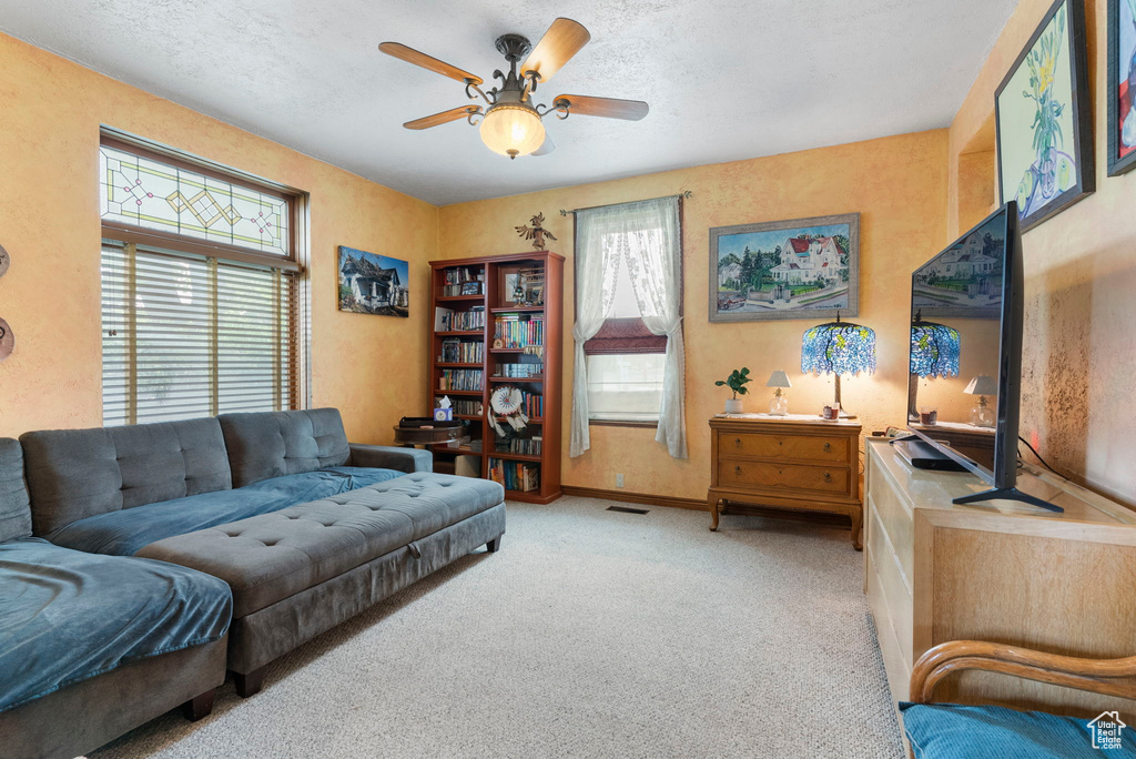 Living room with ceiling fan and carpet floors