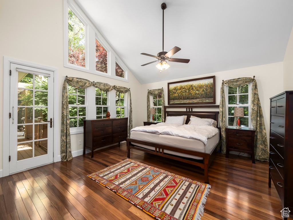 Bedroom featuring high vaulted ceiling, dark wood-type flooring, ceiling fan, and access to exterior