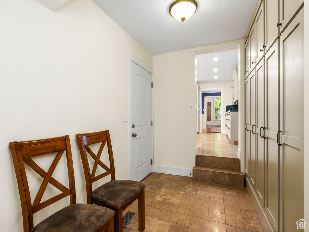 Corridor featuring light tile flooring