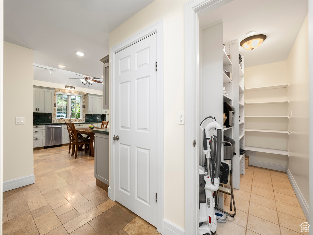 Interior space featuring ceiling fan and light tile floors