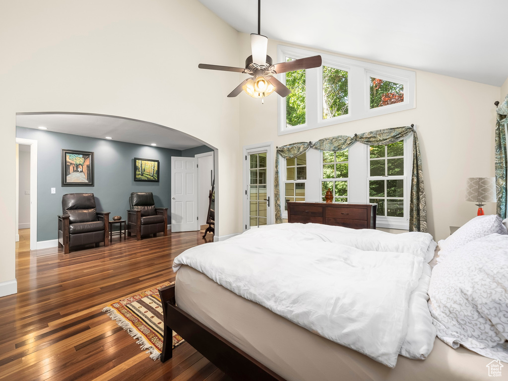 Bedroom featuring high vaulted ceiling, ceiling fan, and dark hardwood / wood-style flooring