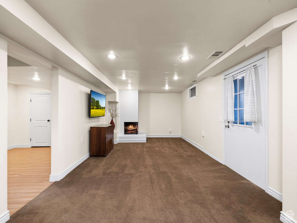 Unfurnished living room featuring carpet flooring