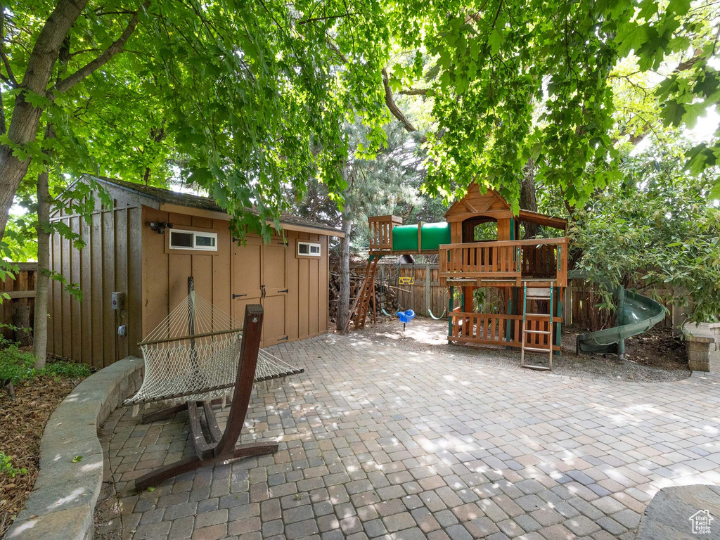 View of patio with a playground