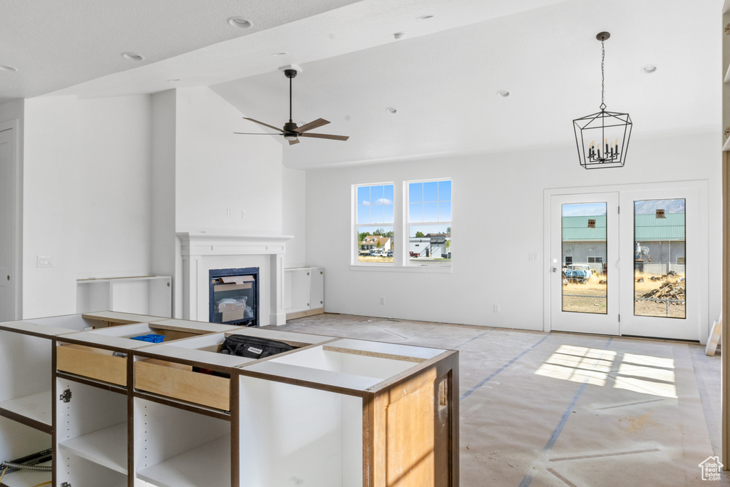 Kitchen with ceiling fan, pendant lighting, and a center island