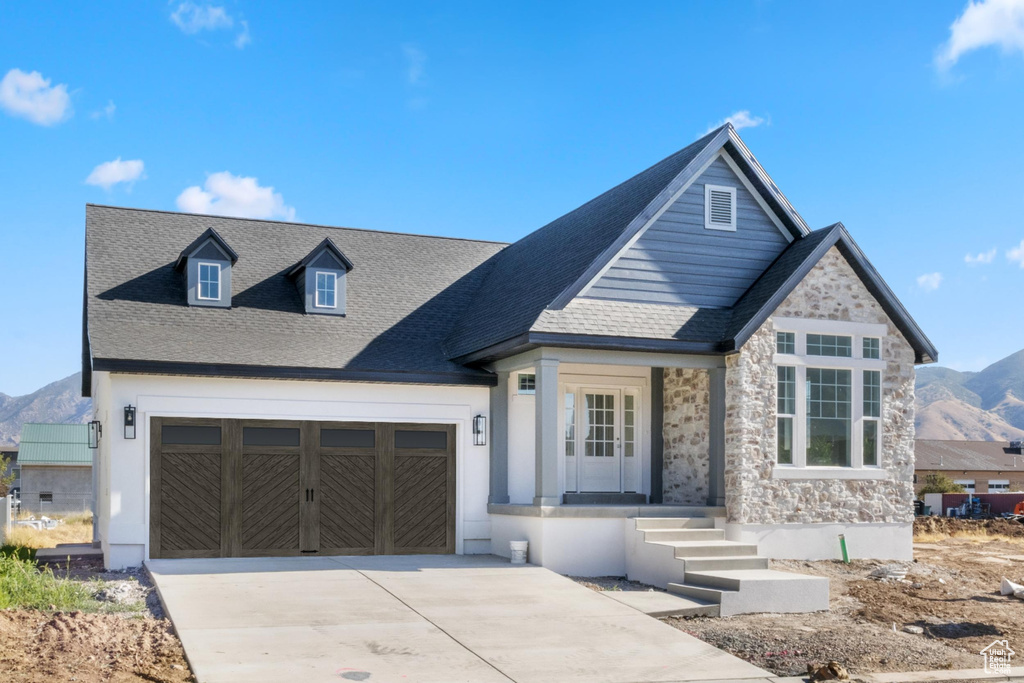 View of front of property featuring a mountain view and a garage