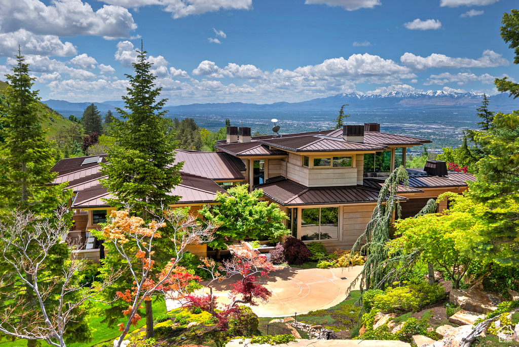 View of front of house featuring a mountain view and a balcony