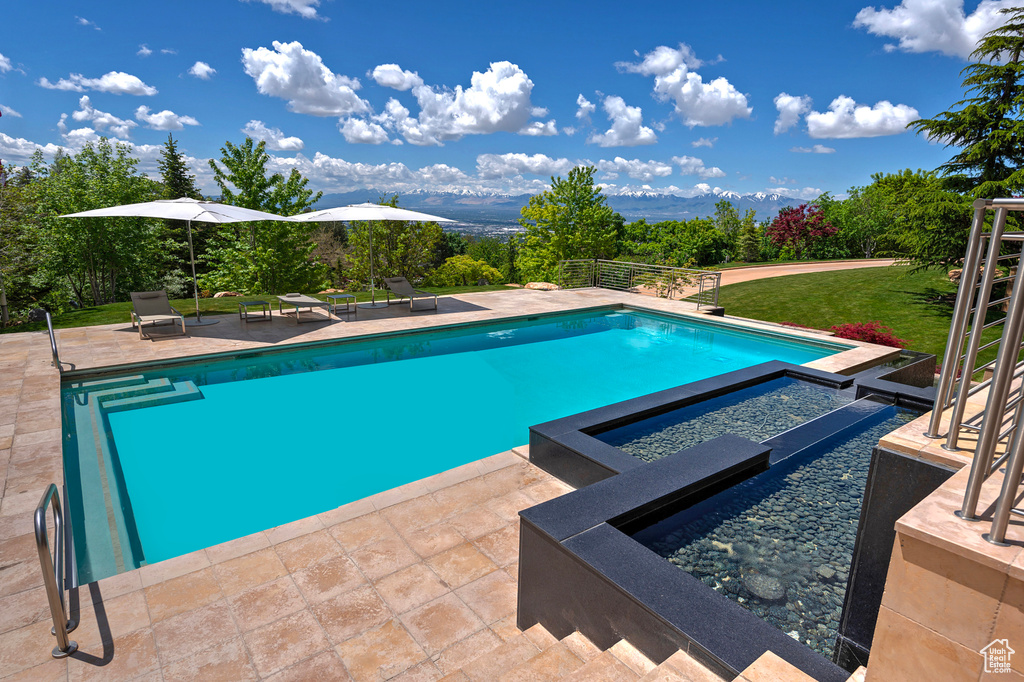 View of swimming pool with a patio area