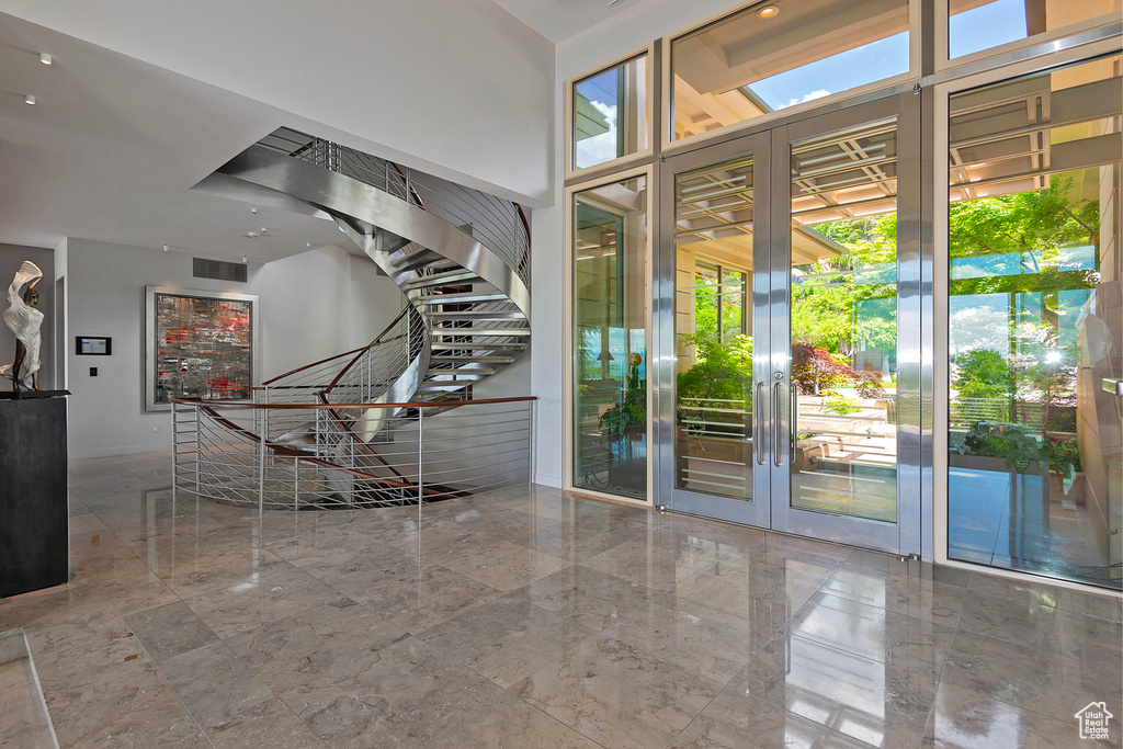 Entrance foyer with tile floors and a high ceiling