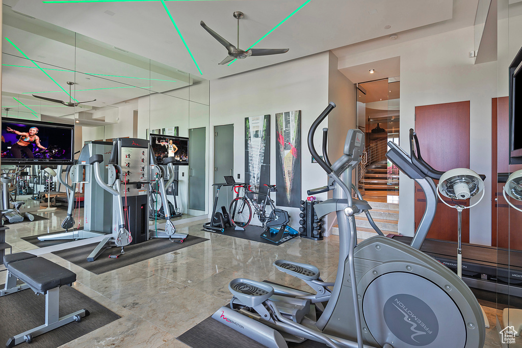 Workout area featuring a high ceiling and ceiling fan