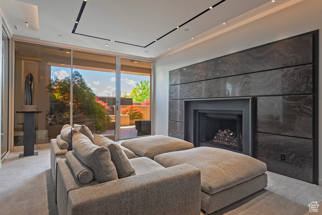 Carpeted living room with floor to ceiling windows