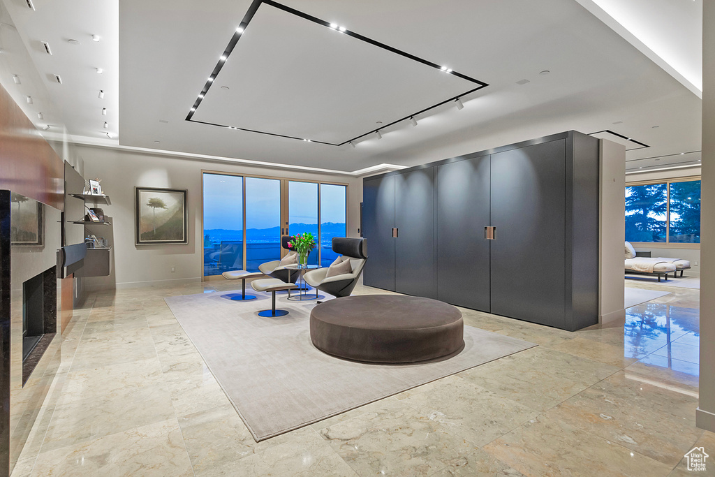 Living room featuring a water view and light tile floors