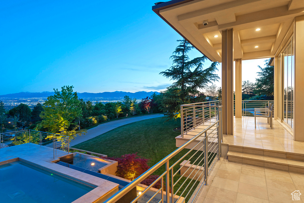 Exterior space featuring a yard, a mountain view, and a balcony