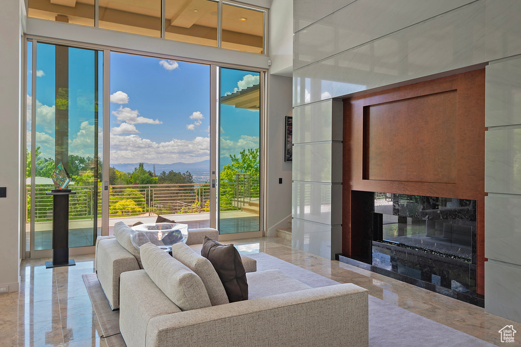 Tiled living room with plenty of natural light and a fireplace