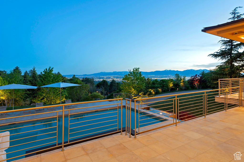 View of patio featuring a balcony and a mountain view