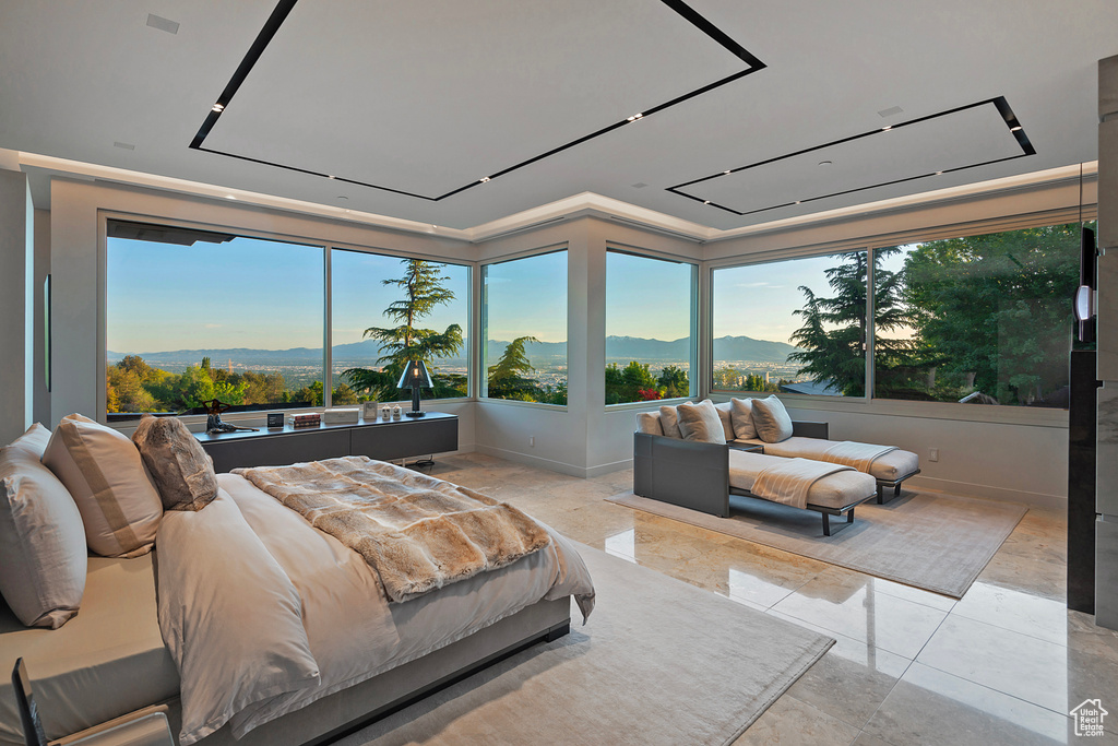 Bedroom featuring a mountain view and light tile floors