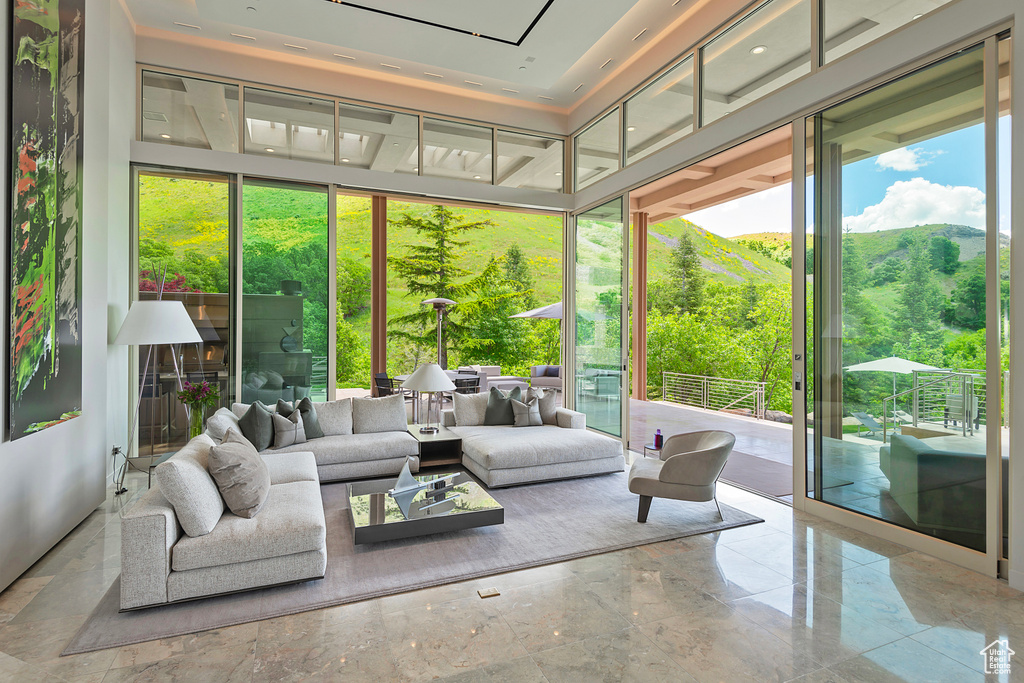 Sunroom with a mountain view and a raised ceiling