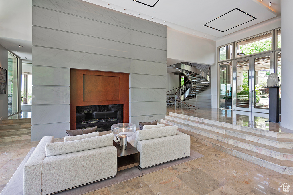 Tiled living room featuring a high end fireplace