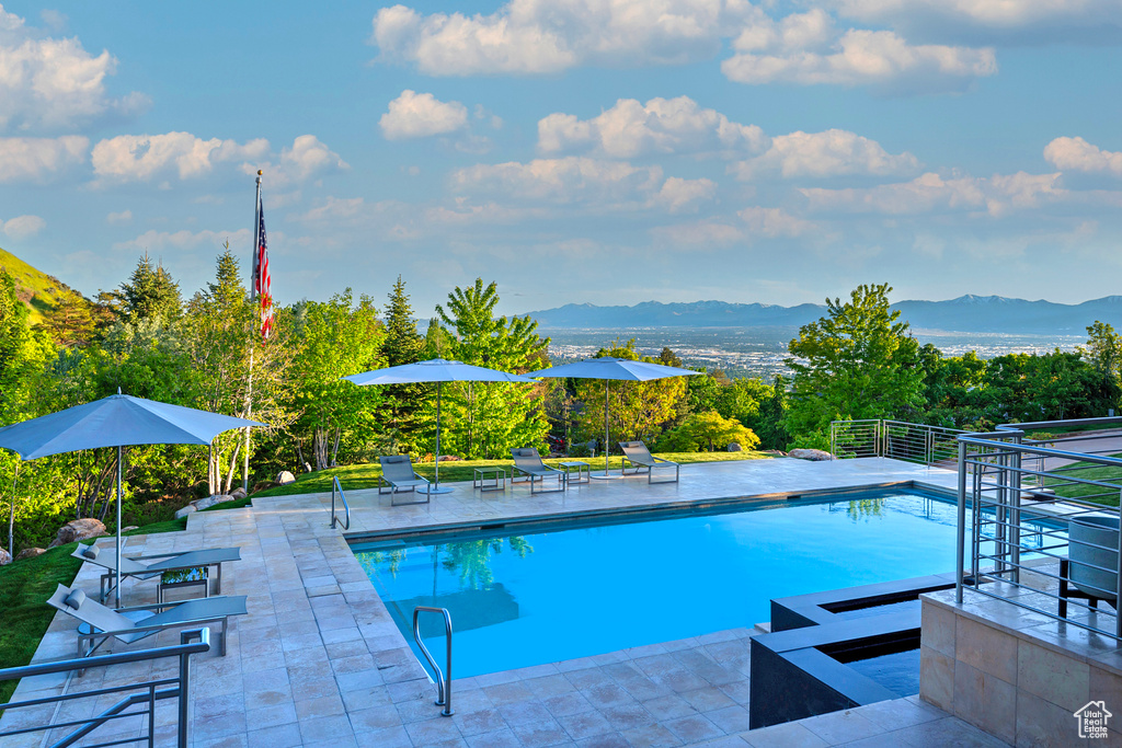 View of pool featuring a patio area and a mountain view