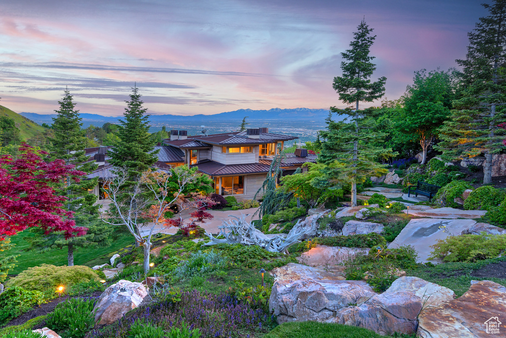 Yard at dusk featuring a mountain view