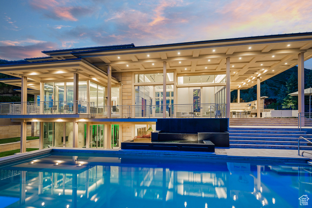 View of pool at dusk