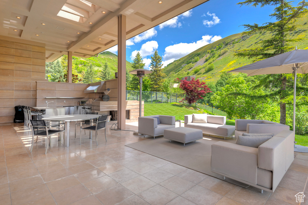 View of patio featuring an outdoor living space and a mountain view