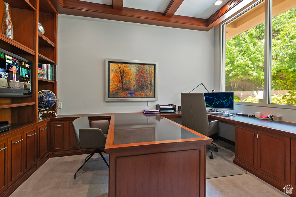 Home office with built in desk and coffered ceiling