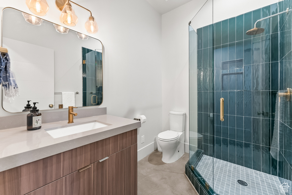 Bathroom with walk in shower, tile flooring, oversized vanity, and toilet