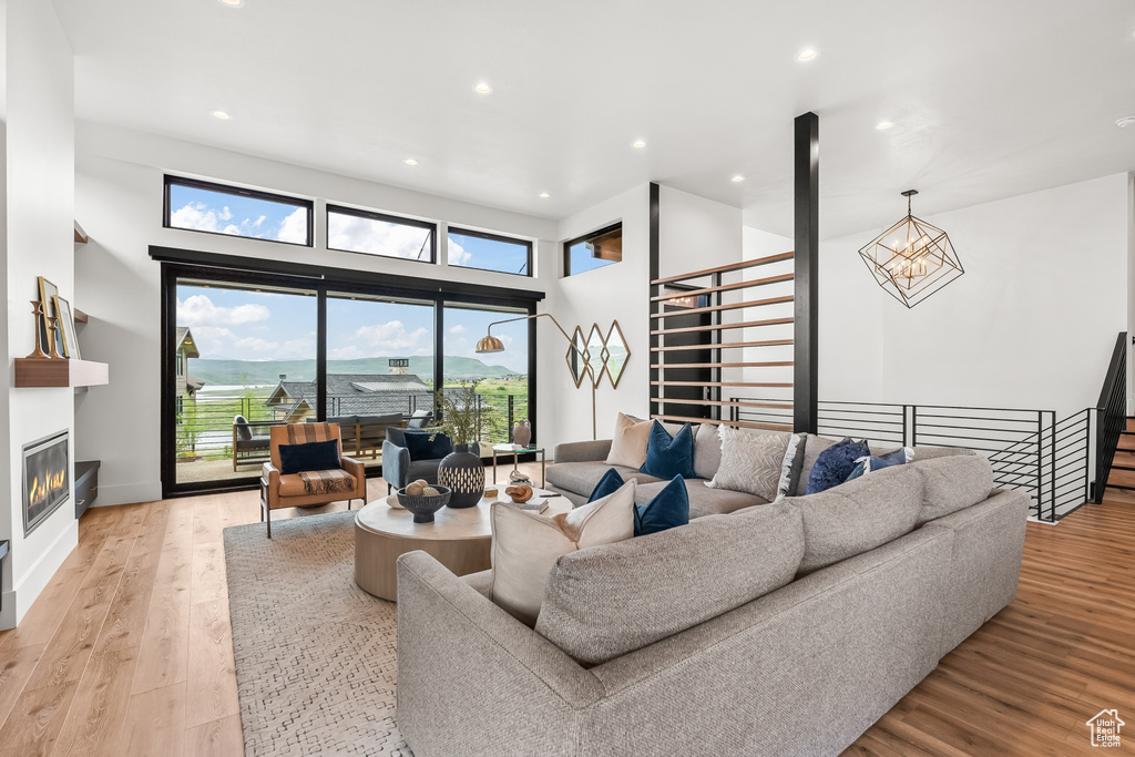 Living room featuring a notable chandelier and light hardwood / wood-style flooring