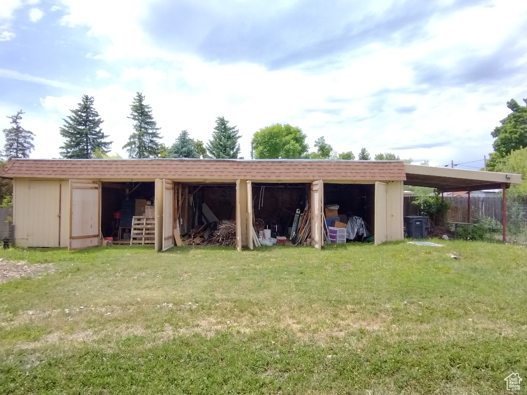 Exterior space featuring a yard and an outdoor structure