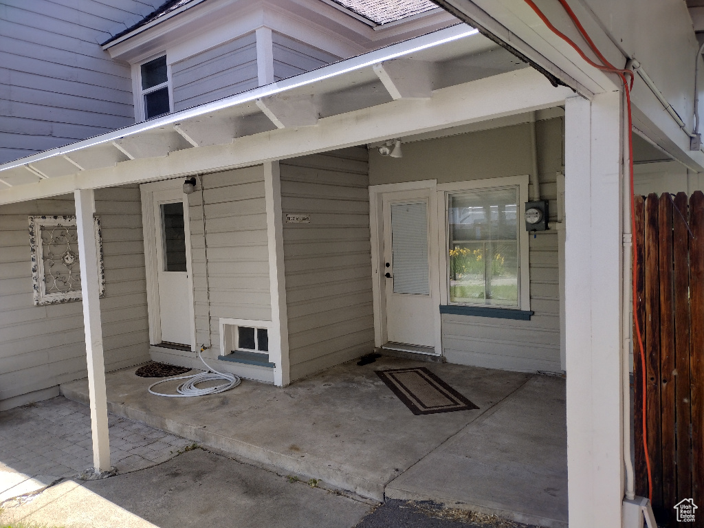 View of exterior entry featuring a patio