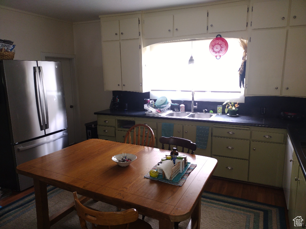 Kitchen with sink, dark hardwood / wood-style floors, stainless steel fridge, and a wealth of natural light