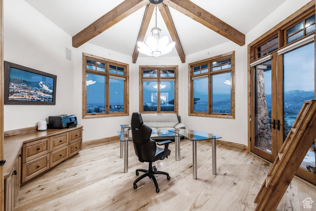 Office area featuring light hardwood / wood-style floors, lofted ceiling with beams, a chandelier, and a mountain view