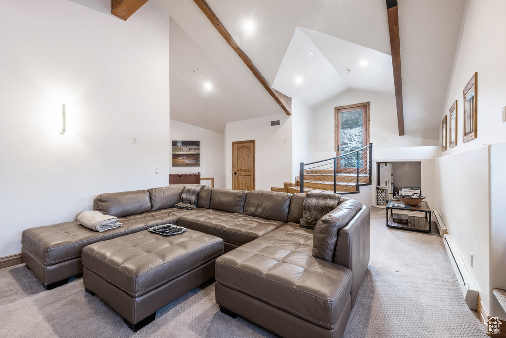 Living room featuring high vaulted ceiling, baseboard heating, carpet, and beam ceiling