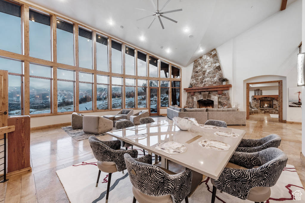 Dining space featuring high vaulted ceiling and a fireplace