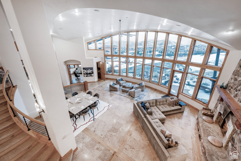 Tiled living room with high vaulted ceiling