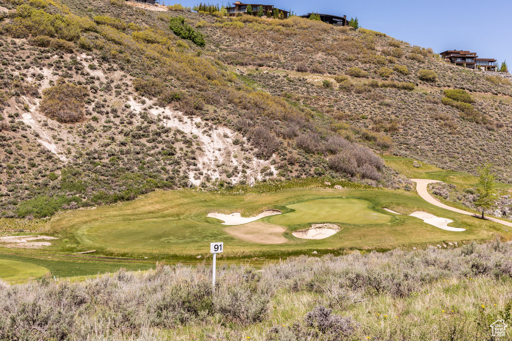 Property view of mountains featuring view of golf course