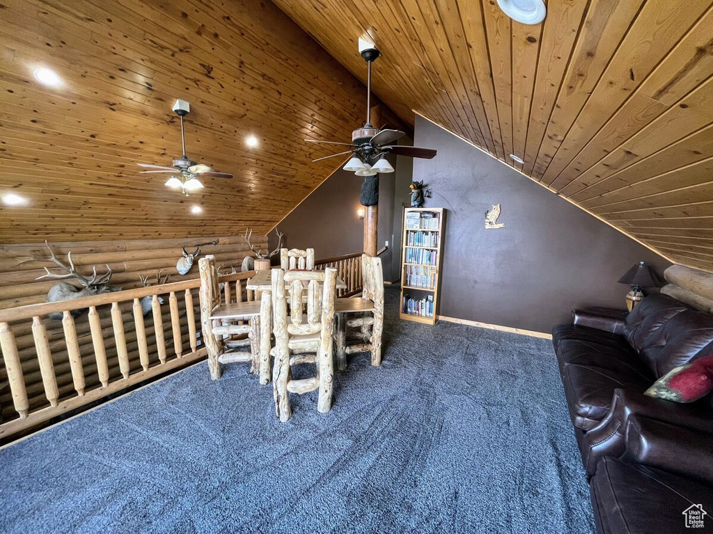 Interior space with ceiling fan, lofted ceiling, carpet flooring, and wood ceiling