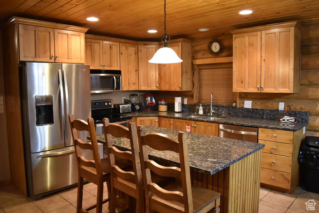 Kitchen with sink, wood ceiling, light tile floors, and stainless steel appliances
