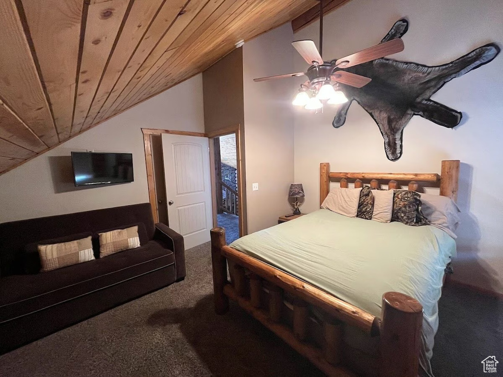Carpeted bedroom featuring vaulted ceiling, ceiling fan, and wood ceiling