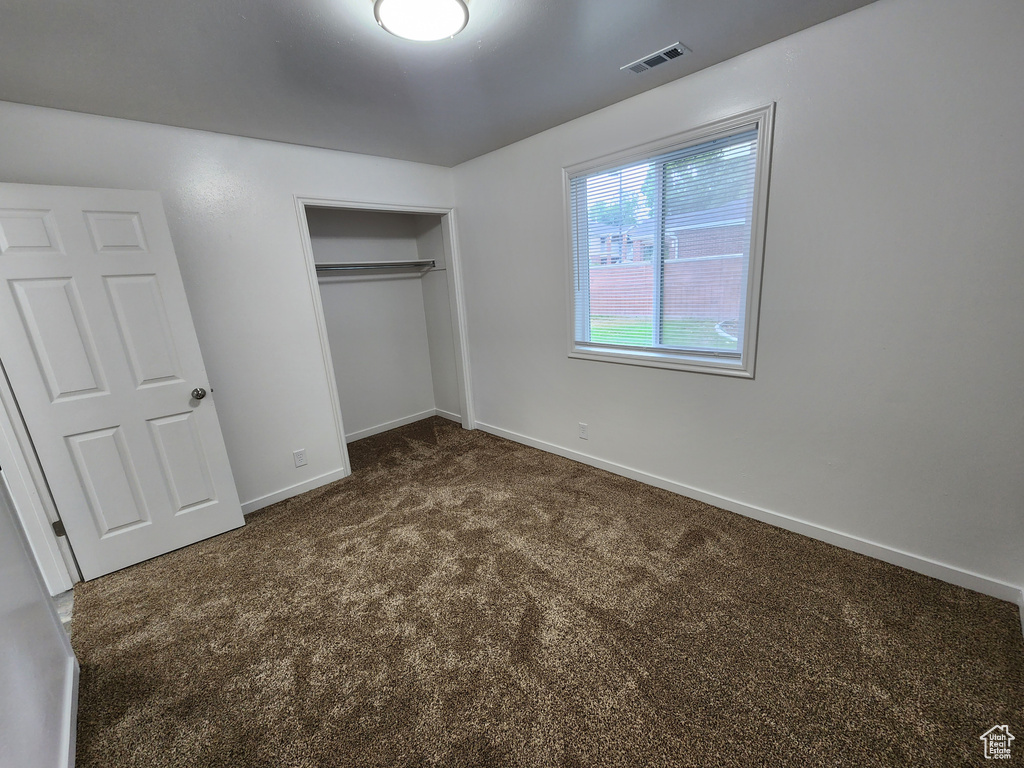 Unfurnished bedroom featuring a closet and carpet flooring