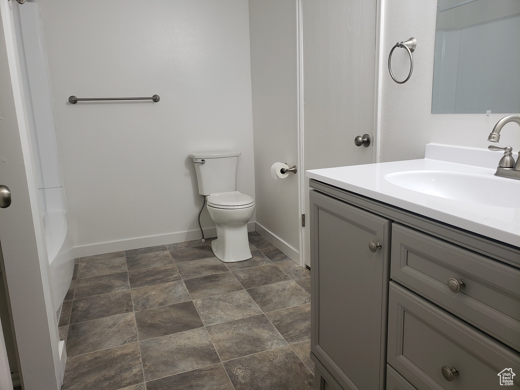 Full bathroom featuring tile flooring, bathing tub / shower combination, vanity, and toilet