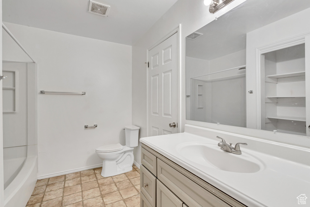 Full bathroom featuring shower / bathtub combination, tile flooring, vanity, and toilet