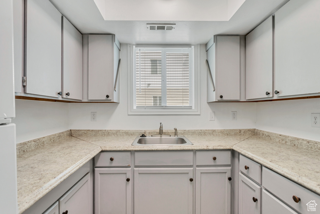 Kitchen featuring sink and gray cabinetry